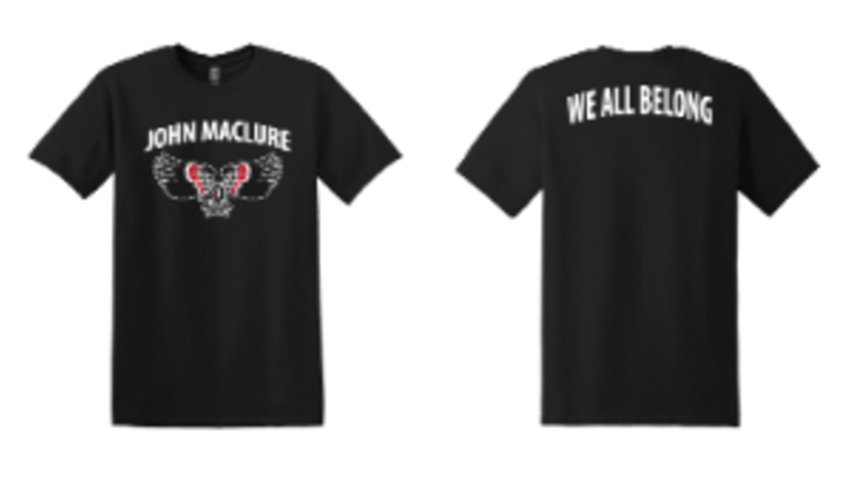 Image of a black t-shirt. Front says John Maclure with the thunderbird logo. Back says We All Belong in white.