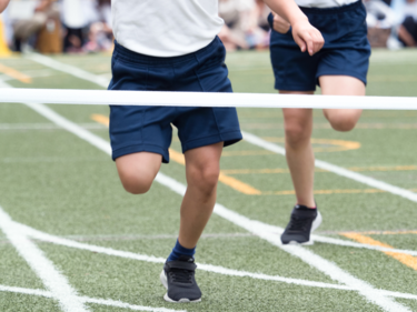 Photo of two children racing on foot.