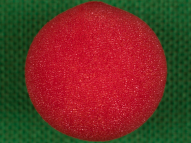 Red foam ball on top of a green knit