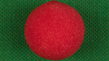 Red foam ball on top of a green knit