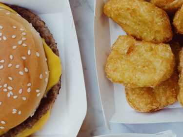 Close up image of a cheeseburger and chicken nuggets
