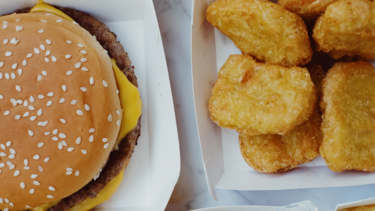 Close up image of a cheeseburger and chicken nuggets