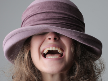A photo of a girl wearing a hat and smiling