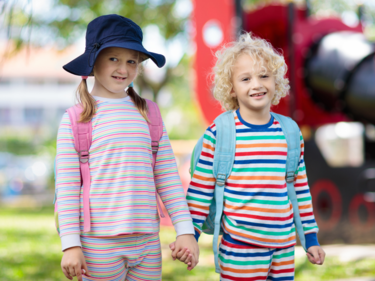 Two elementary students wearing striped pajamas